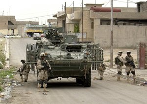 Soldiers of Comanche Company 1-23 Infantry, 3rd Brigade, 2nd Infantry Division Stryker Brigade Combat Team (SBCT) dismount a Stryker Infantry Carrier Vehicle (ICV)  to do a foort march in Mosul, Iraq on May 13, 2004. 
(Photo: U.S. Army/Sgt. Jeremiah Johnson)
