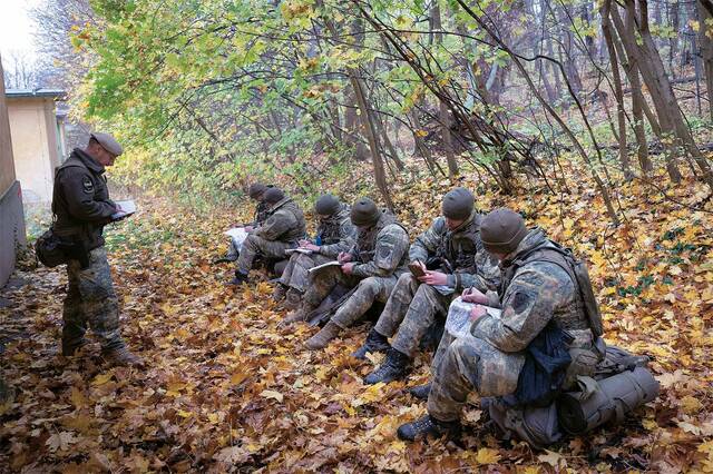 Die Offiziersanwärter (re.) müssen bei ihrem letzten Führungstraining neben den Belastungen strukturiert beurteilen und befehlen. Hier erhalten sie einen Funkbefehl. (Foto: Bundesheer/Gunter Pusch)