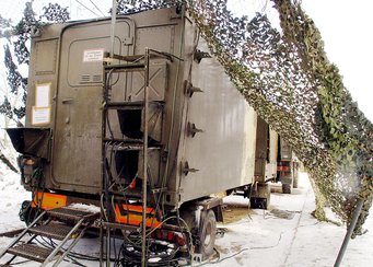 Knotenvermittlung im Aufklärungs- und Zielzuweisungsradar mit dem Operation Shelter unter einem Tarnnetz. (Foto: Horst Treiblmaier)