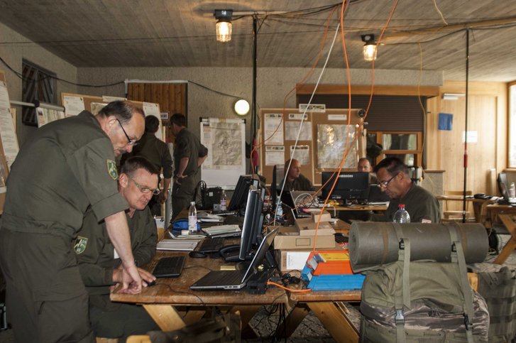 Der Stab beim Planen am Gefechtsstand und beim anschließenden Lagevortrag. (Foto: Majewski)