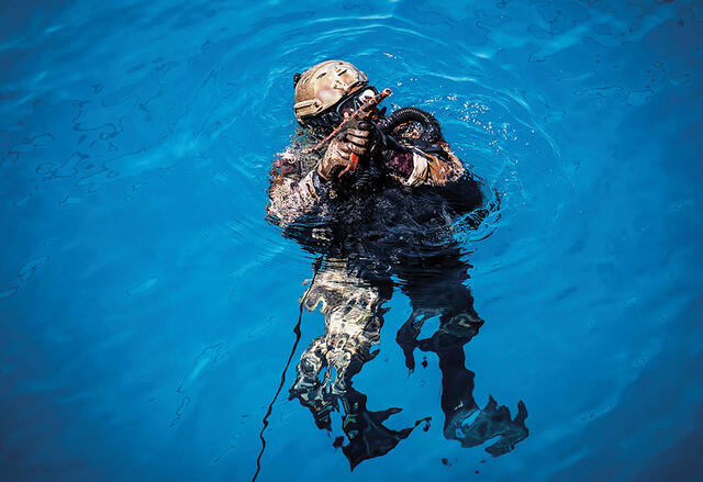 Ein Kampfschwimmer sichert aus dem Wasser (hier auf ein hohes Objekt wie ein Schiff oder eine Hafenanlage). (Foto: Bundesheer/Paul Kulec)