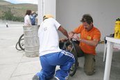 Werner Planer (re.) und ein Helfer reparieren den Reifen von Luis in der Box. (Foto: Archiv Wildpanner)